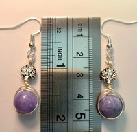 Silver wire wrapped earrings with Tree of Life beads and lavender round beads measured against a ruler at 2 inches