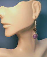 A mannequin  with a Silver wire wrapped earrings with Tree of Life bead and lavender round bead