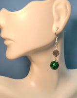 A mannequin with Silver wire wrapped earring with Tree of Life beads and green malachite round beads