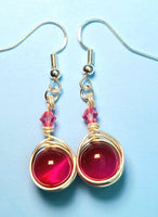 Image of 1 pair of earrings with pink tiger eye 10mm beads wrapped by silver wire and topped by a pink 4mm Swarovski crystal