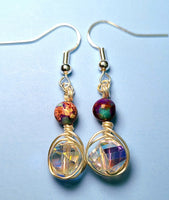 Image of a pair of earrings with 10mm AB coated spiral crystals wrapped with silver wire and topped with galaxy jasper