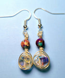 Image of a pair of earrings with 10mm AB coated spiral crystals wrapped with silver wire and topped with galaxy jasper