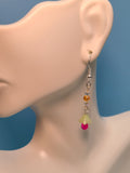 Image of light green and hot pink flower earrings on a mannequin