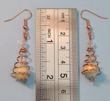 Image of copper earrings with round jasper beads compared to a ruler at 2 inches long