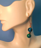 Image of a mannequin wearing an earring of Phoenix beads separated by a copper bead