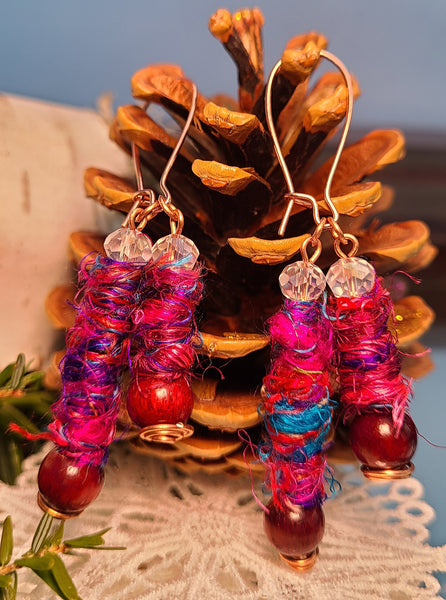 Image of earrings made of Silk Sari Yarn, round Sandalwood beads, crystal beads and copper wire 