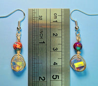 Image of a pair of earrings with 10mm AB coated spiral crystals wrapped with silver wire and topped with galaxy jasper next to a ruler measuring 1 3/4"