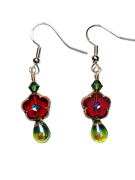 Picture of Red sparkly flowers with a green crystal above and shiny glass drop below. Dangling from gold toned sterling silver hooks. 